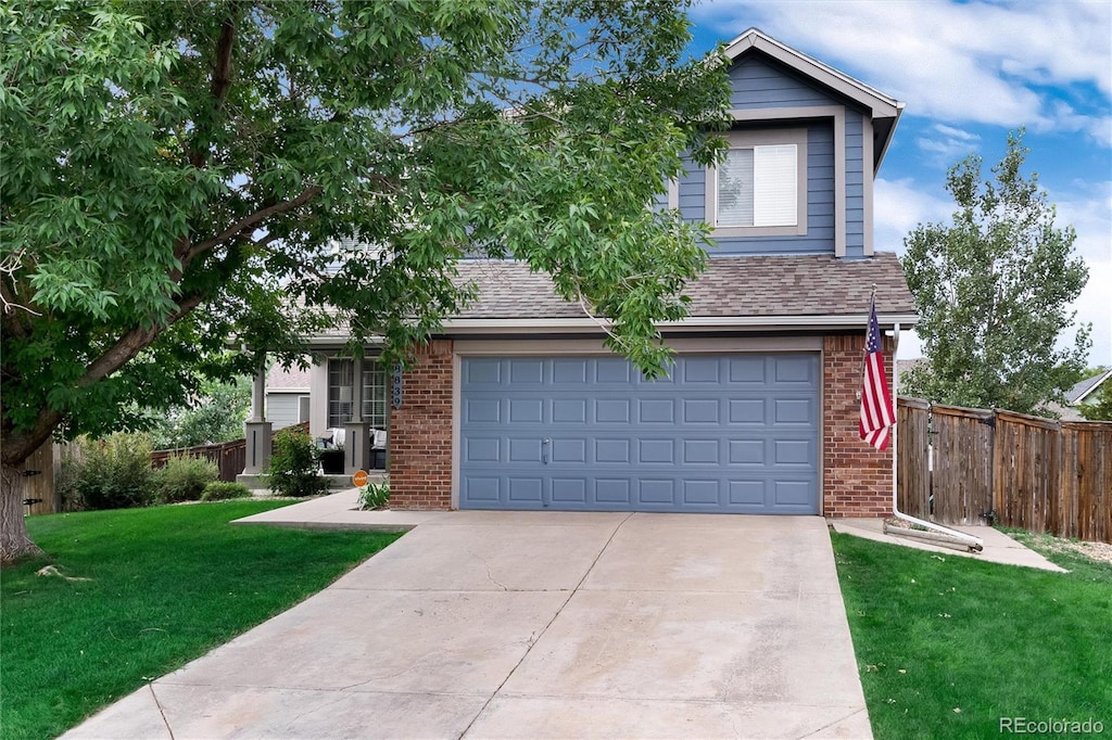 view of front facade with a front yard and a garage