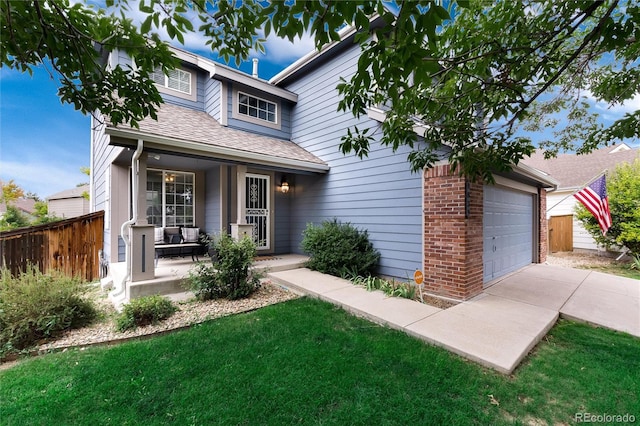 view of front of home featuring a porch, a front lawn, and a garage