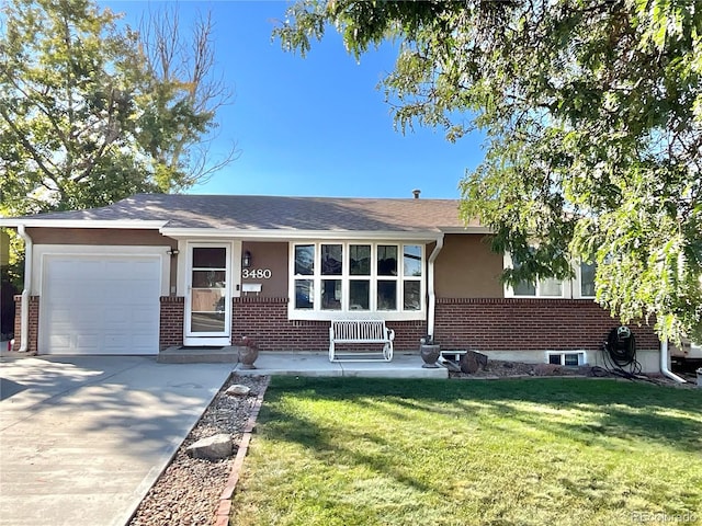 ranch-style house featuring a garage and a front lawn