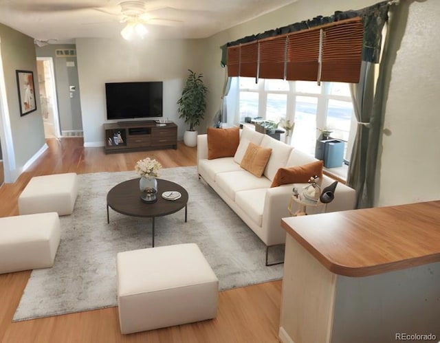 living room featuring ceiling fan and light hardwood / wood-style flooring