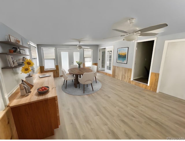 dining room featuring french doors and light hardwood / wood-style flooring