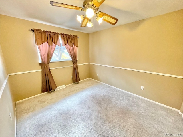 carpeted spare room with ceiling fan