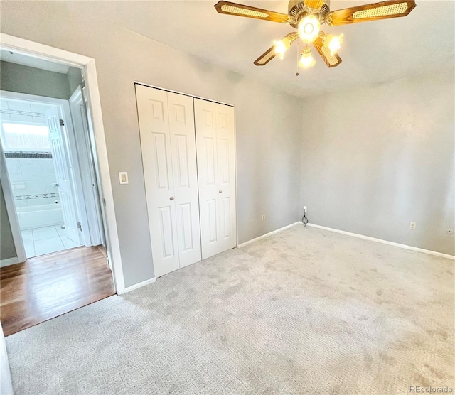 unfurnished bedroom with ceiling fan, a closet, and light carpet