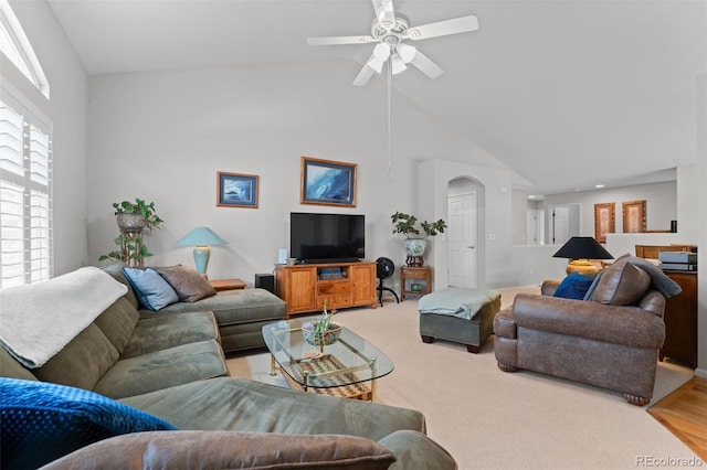 living room with light carpet, high vaulted ceiling, and a ceiling fan