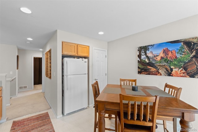 dining area featuring light floors, baseboards, visible vents, and recessed lighting