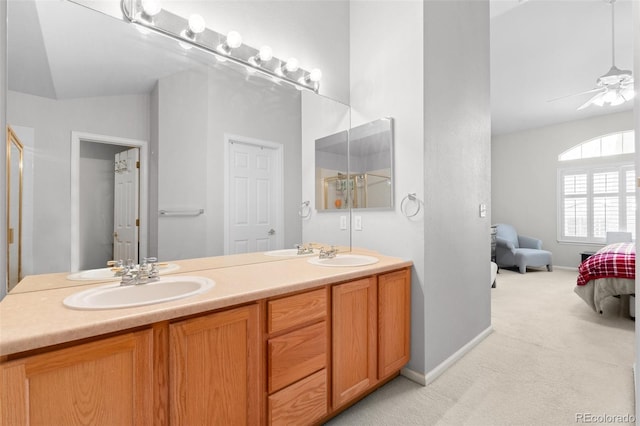 ensuite bathroom with lofted ceiling, a sink, a ceiling fan, and ensuite bathroom