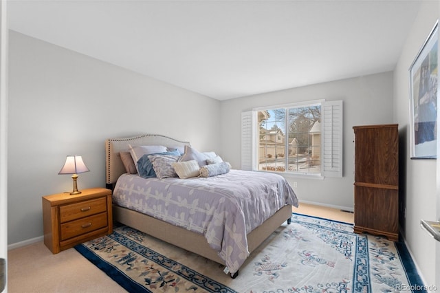 bedroom with baseboards and carpet flooring