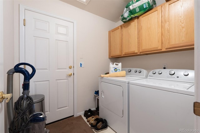 washroom featuring independent washer and dryer and cabinet space