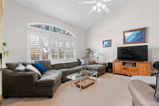 carpeted living room featuring a ceiling fan and high vaulted ceiling