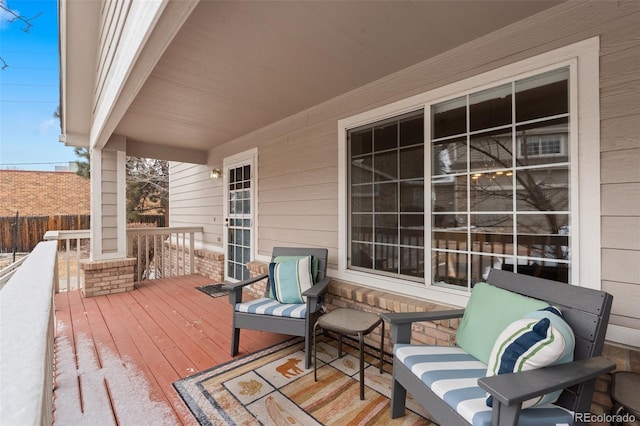 wooden terrace featuring fence