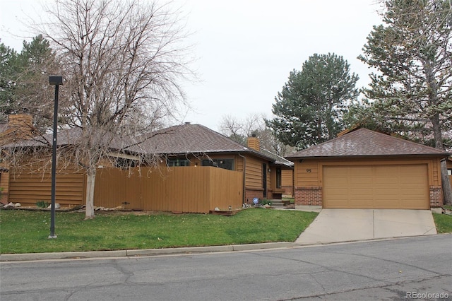 view of front of home with a front lawn, brick siding, driveway, and a garage