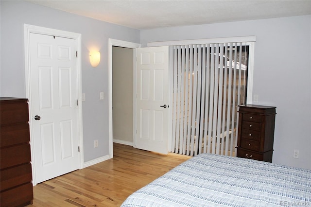 bedroom with baseboards and light wood-type flooring