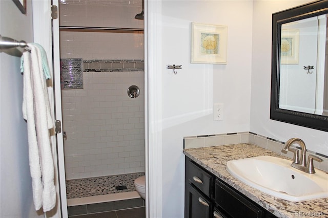 full bathroom featuring tile patterned floors, vanity, a shower stall, and toilet