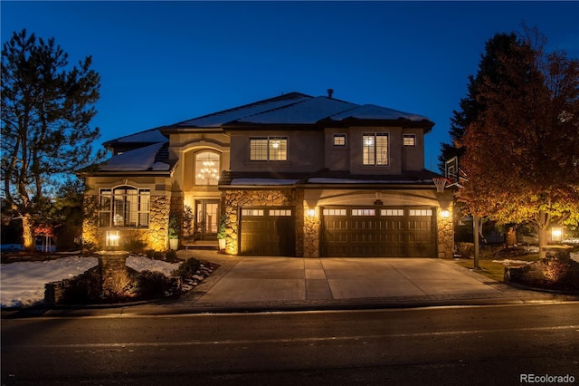 9445 Aspen Hill Cir, Lone Tree, CO 80124 - view of front of home featuring stone siding, an attached garage, stucco siding, and concrete driveway