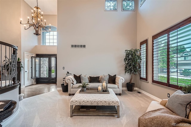 9445 Aspen Hill Cir, Lone Tree, CO 80124 - living room with a high ceiling, carpet floors, a chandelier, and baseboards