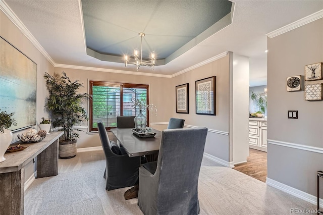 9445 Aspen Hill Cir, Lone Tree, CO 80124 - dining space with a chandelier, a raised ceiling, light colored carpet, ornamental molding, and a textured ceiling