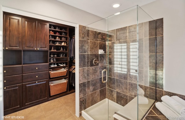 9445 Aspen Hill Cir, Lone Tree, CO 80124 - bathroom featuring a shower stall, tile patterned floors, and a walk in closet
