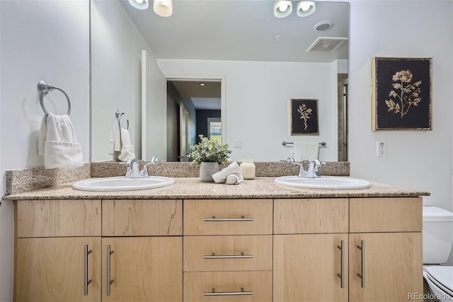 bathroom featuring vanity and toilet