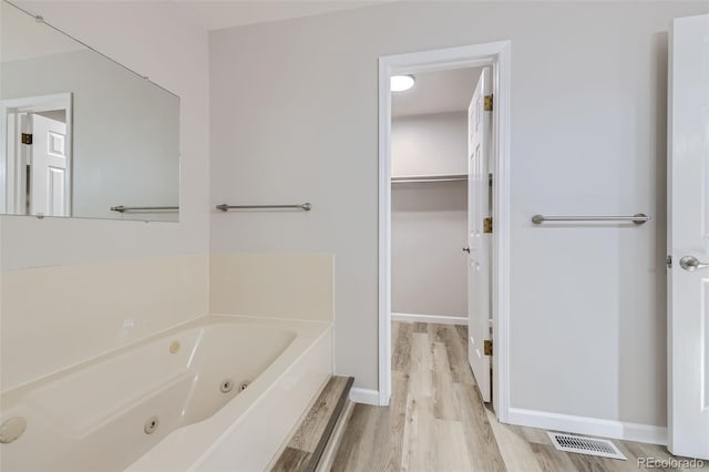 bathroom with hardwood / wood-style floors and a washtub