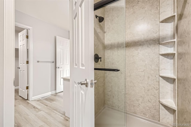 bathroom with walk in shower and hardwood / wood-style flooring