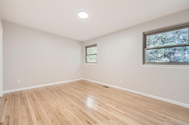 spare room featuring light hardwood / wood-style flooring