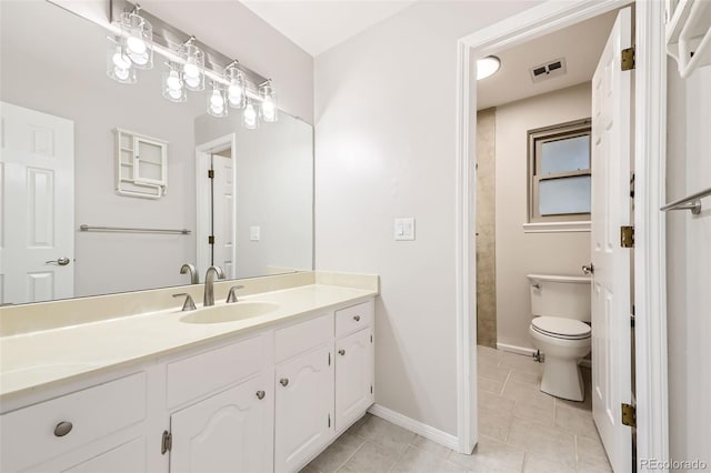 bathroom featuring toilet, vanity, and tile patterned flooring