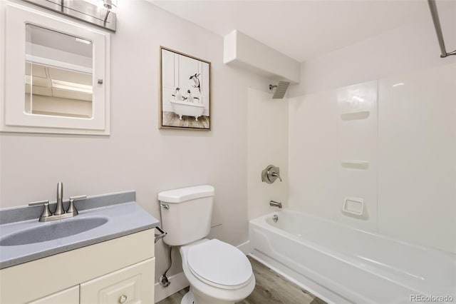 full bathroom featuring hardwood / wood-style flooring, vanity, bathing tub / shower combination, and toilet