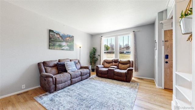 9758 Laredo St Unit 22D, Commerce City, CO 80022 - living area with baseboards, visible vents, and light wood-style floors