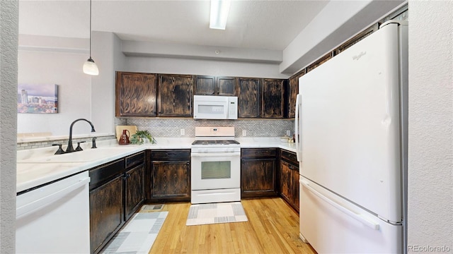 9758 Laredo St Unit 22D, Commerce City, CO 80022 - kitchen with dark brown cabinets, white appliances, decorative backsplash, and a sink