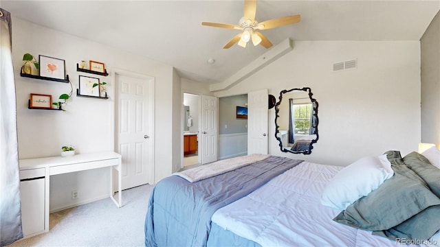 9758 Laredo St Unit 22D, Commerce City, CO 80022 - bedroom featuring ensuite bath, visible vents, vaulted ceiling, ceiling fan, and light carpet