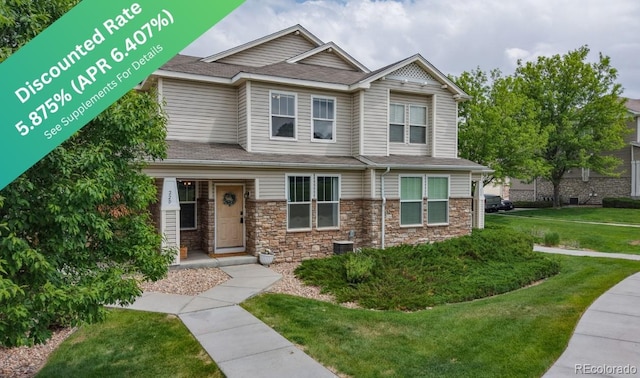 9758 Laredo St Unit 22D, Commerce City, CO 80022 - view of front facade featuring a front yard, stone siding, and roof with shingles