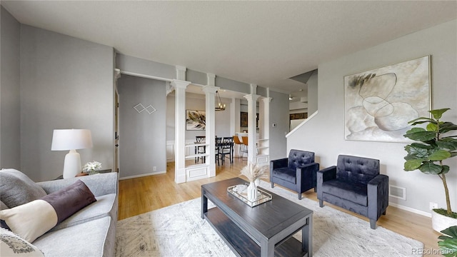 9758 Laredo St Unit 22D, Commerce City, CO 80022 - living room with decorative columns and wood finished floors