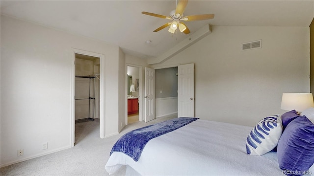 9758 Laredo St Unit 22D, Commerce City, CO 80022 - bedroom featuring light colored carpet, vaulted ceiling, a spacious closet, connected bathroom, and a ceiling fan
