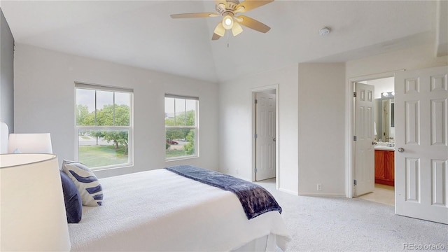 9758 Laredo St Unit 22D, Commerce City, CO 80022 - bedroom with vaulted ceiling, light carpet, ensuite bath, and a ceiling fan