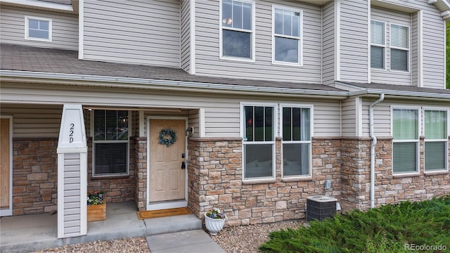 9758 Laredo St Unit 22D, Commerce City, CO 80022 - doorway to property featuring stone siding