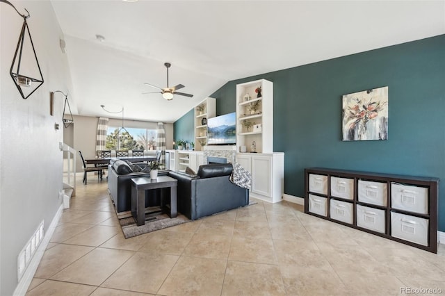 living area featuring visible vents, built in features, light tile patterned floors, lofted ceiling, and ceiling fan