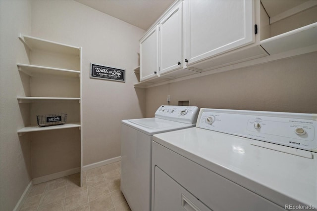 washroom featuring cabinet space, light tile patterned floors, baseboards, and washing machine and clothes dryer