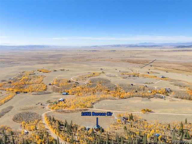 birds eye view of property featuring a mountain view