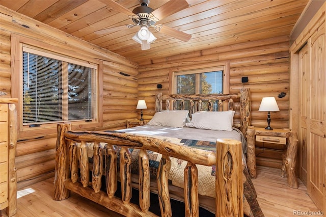 bedroom featuring wood ceiling, ceiling fan, log walls, and light hardwood / wood-style floors