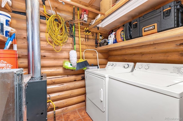 washroom featuring tile patterned floors, log walls, and washer and clothes dryer