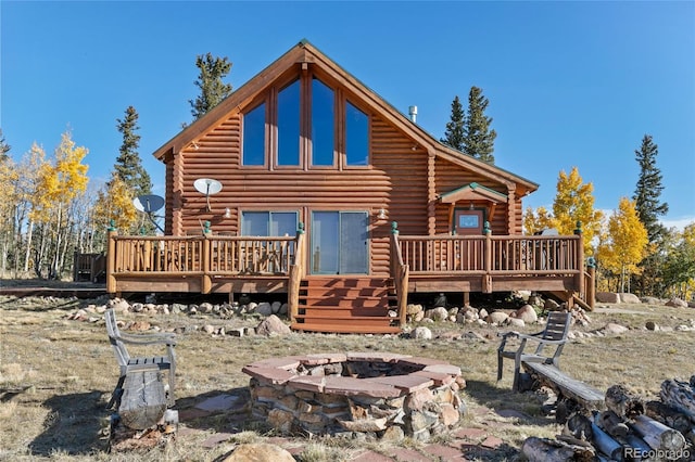 1052 Boreas Cir, Jefferson, CO 80456 - rear view of house featuring an outdoor fire pit, log siding, and a wooden deck