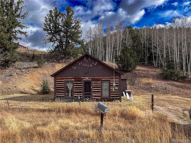 log home with an outdoor structure