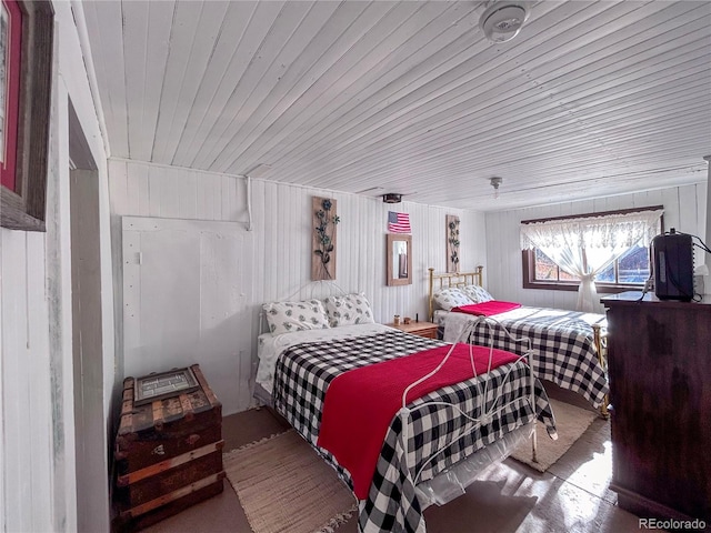 bedroom featuring wood walls and wooden ceiling