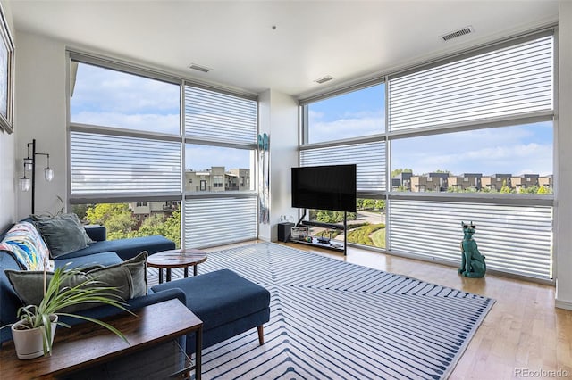2958 Syracuse St Unit 403, Denver, CO 80238 - living area featuring wood finished floors, plenty of natural light, and a wall of windows