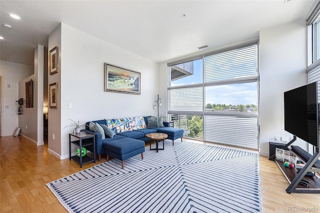2958 Syracuse St Unit 403, Denver, CO 80238 - living area featuring expansive windows, light wood finished floors, and baseboards