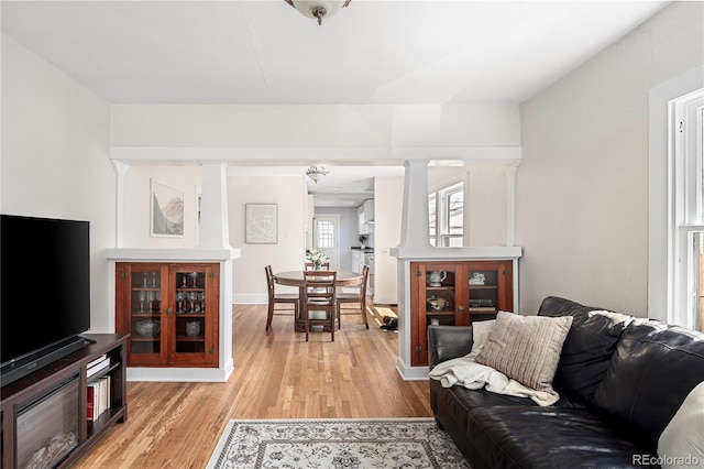 2676 S Lincoln St, Denver, CO 80210 - living area with baseboards, light wood-type flooring, and ornate columns