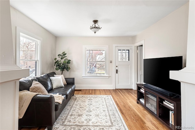 2676 S Lincoln St, Denver, CO 80210 - living room with baseboards, a wealth of natural light, and light wood finished floors
