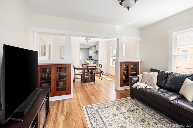2676 S Lincoln St, Denver, CO 80210 - living area with decorative columns and light wood-style floors
