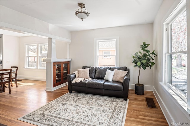 2676 S Lincoln St, Denver, CO 80210 - living area featuring baseboards, visible vents, and wood finished floors