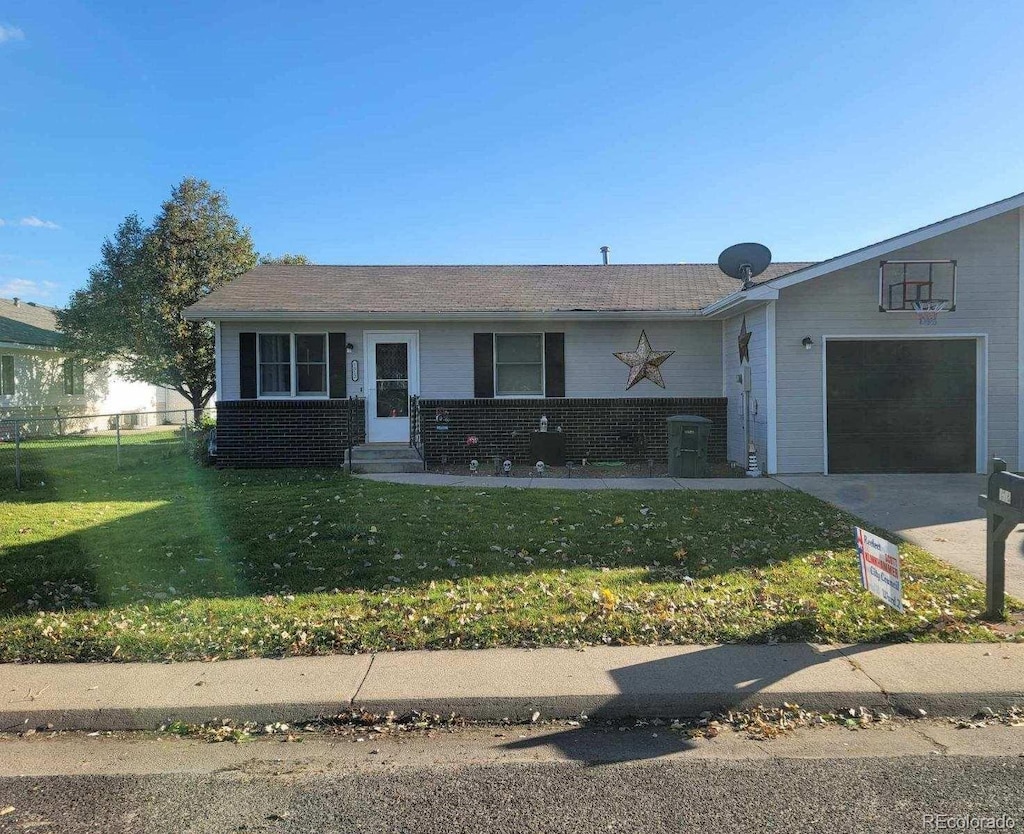 view of front of home with a front lawn and a garage